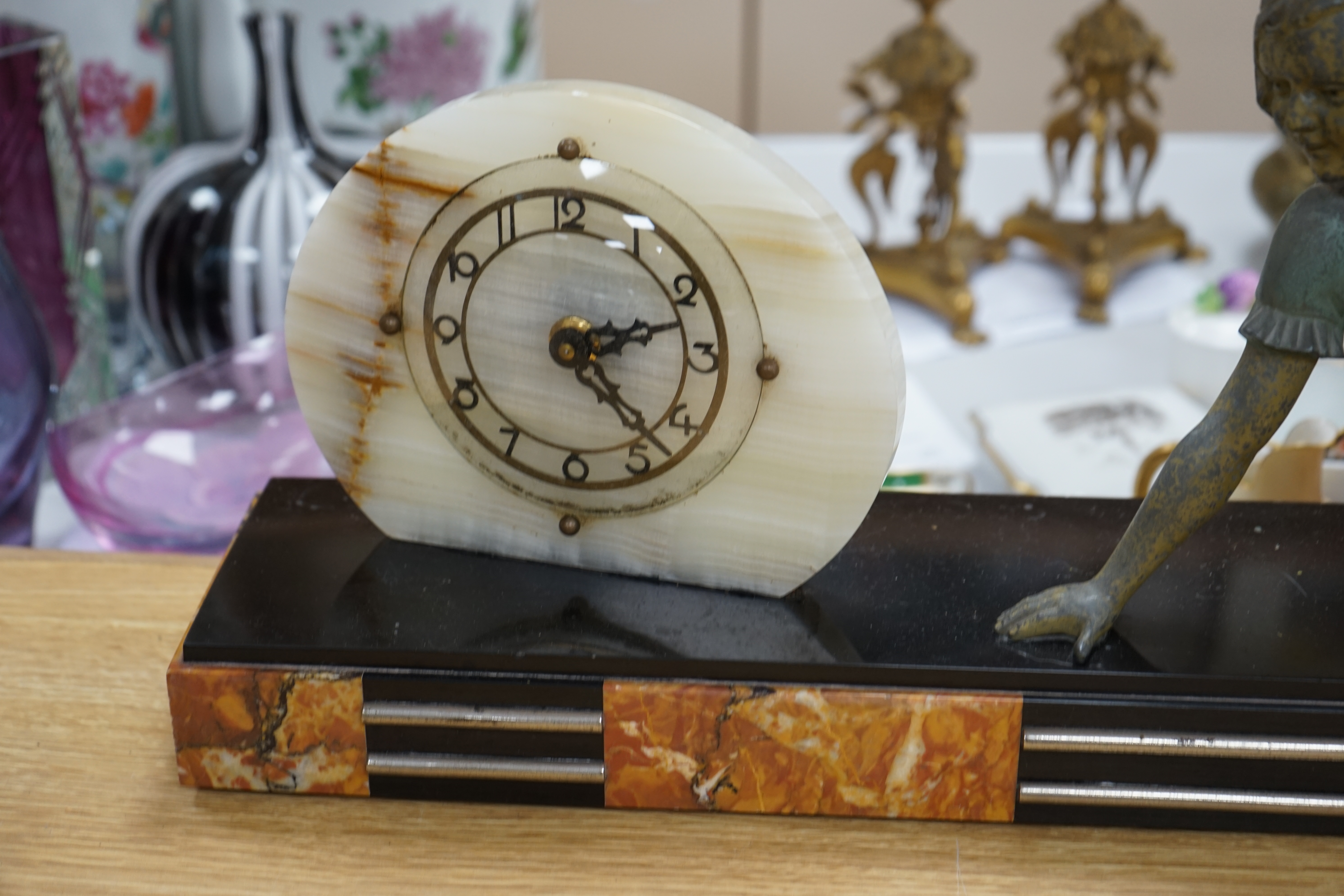 An Art Deco marble and chrome mantel clock, with painted spelter reclining figure, 66.5cm. Condition - paint worn on figure